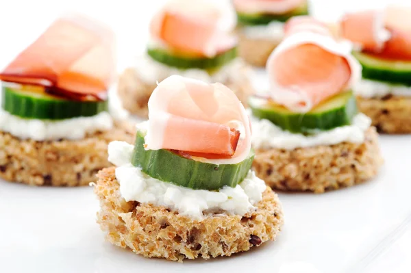 Mini toasts topped with cheese — Stock Photo, Image