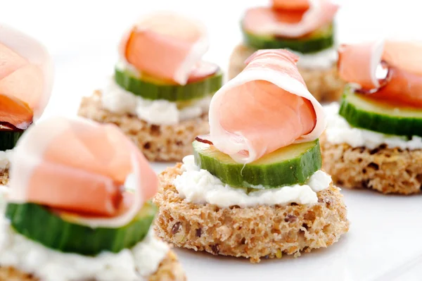 Mini toasts topped with cheese — Stock Photo, Image