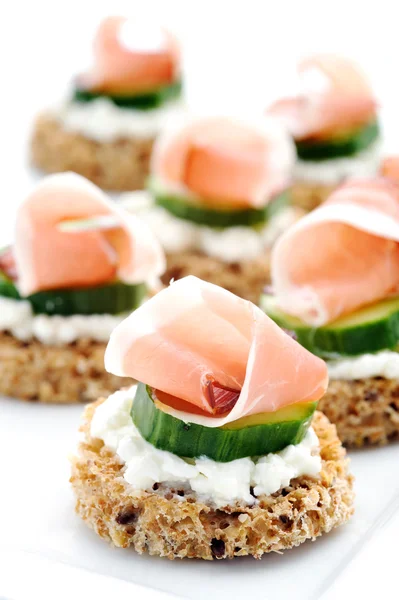 Mini toasts topped with cheese — Stock Photo, Image