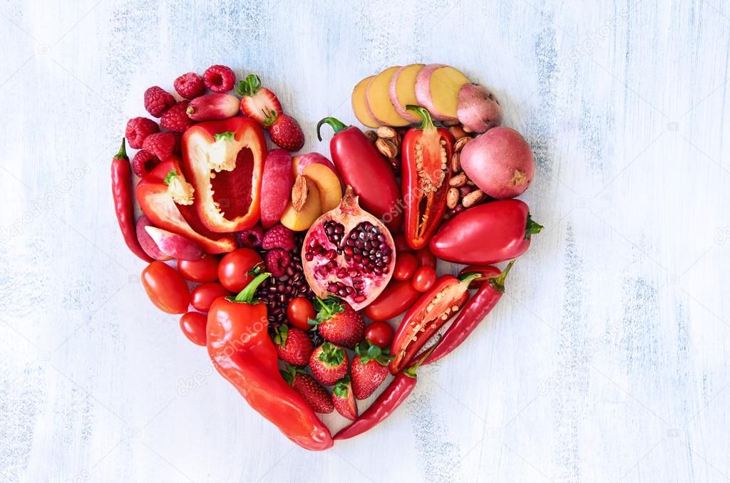 Red heart made from fresh raw fruits and vegetables