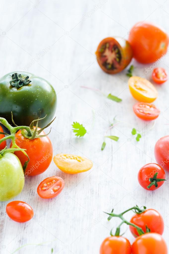 tomatoes on rustic background with leaves