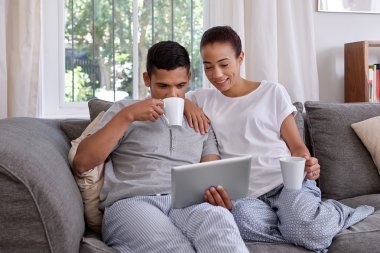 couple having coffee and looking at tablet clipart