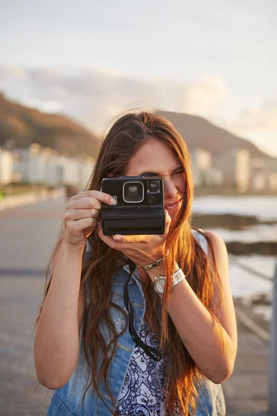 Woman taking pictures on beach Stock Photo