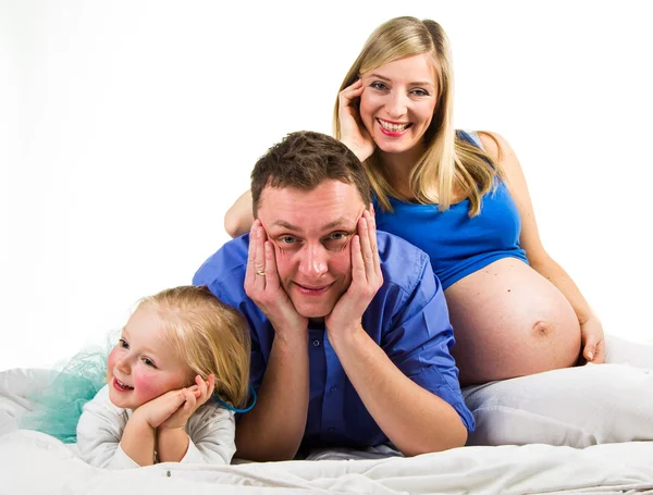 Pregnant mother, father and preschool daughter on white — Stock Photo, Image