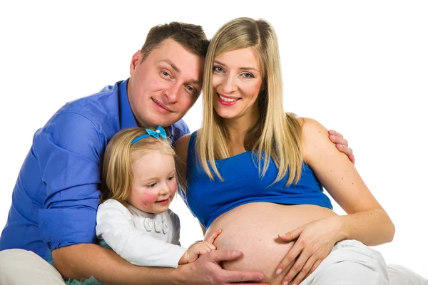 Mãe grávida, pai e filha pré-escolar em branco Imagem De Stock