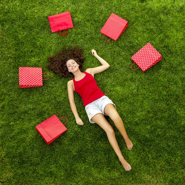 Mujer rodeada de bolsas de regalo — Foto de Stock