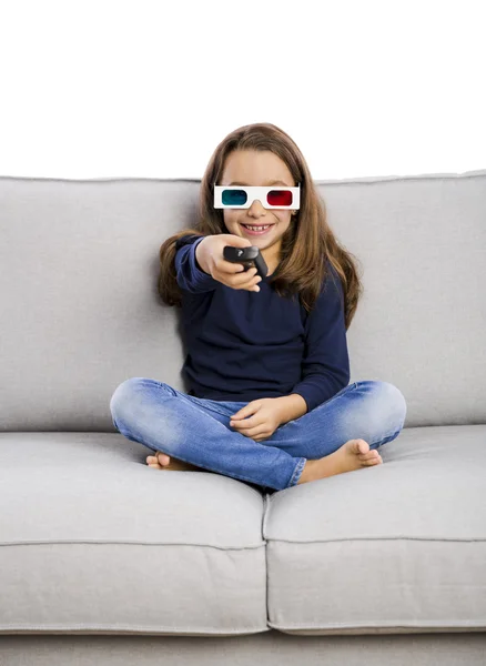 Menina segurando um controle remoto TV — Fotografia de Stock