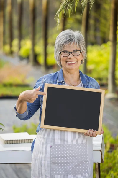 Donna anziana in una casa verde — Foto Stock