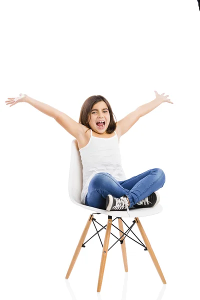 Beautiful young girl sitting on a chair — Stock Photo, Image