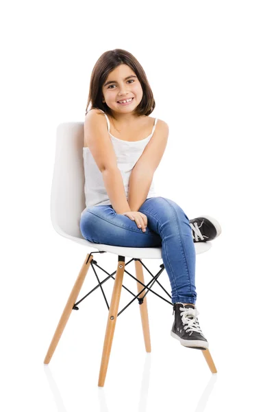 Beautiful young girl sitting on a chair — Stock Photo, Image