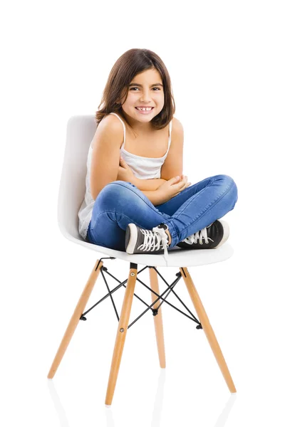 Beautiful young girl sitting on a chair — Stock Photo, Image