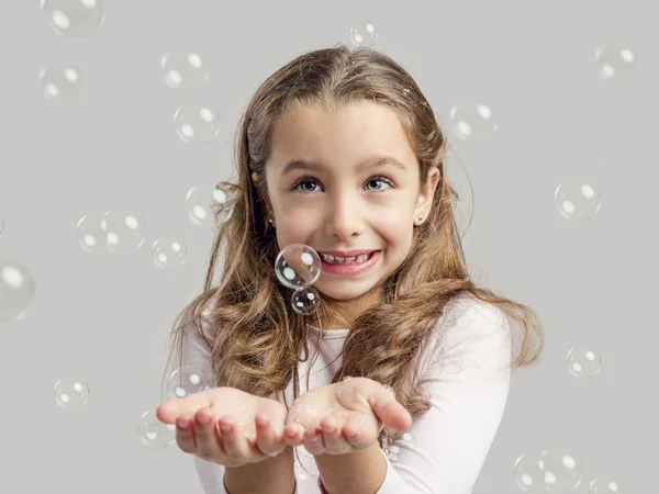 Girl playing with soap bubbles — Stock Photo, Image