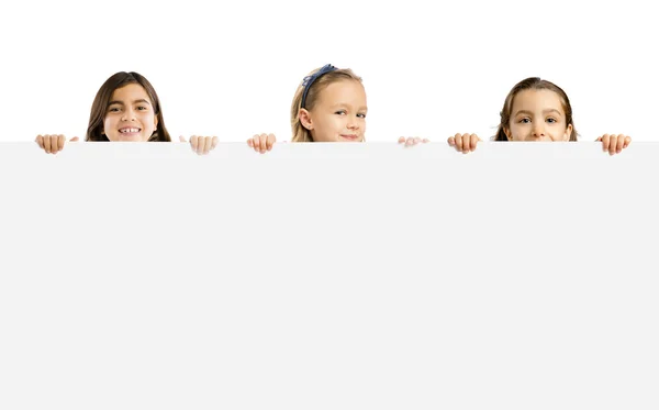 Little girls holding a white board — Stock Photo, Image