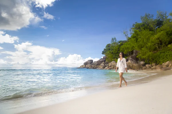 Una bella donna che cammina sulla spiaggia — Foto Stock