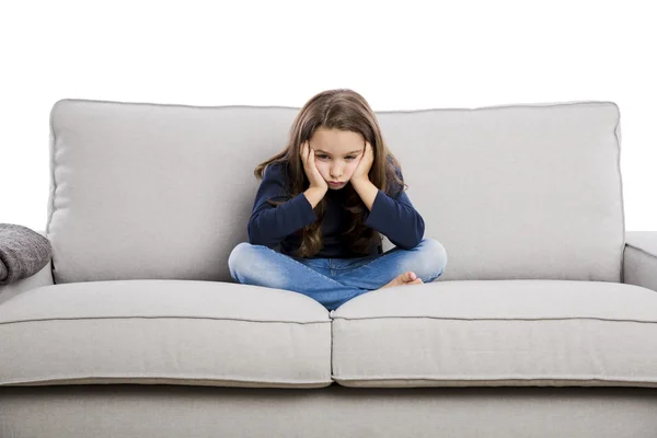 Girl sitting on couch upset — Stock Photo, Image