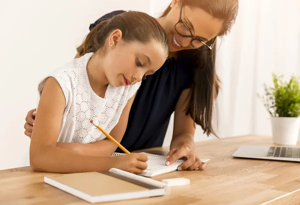 Мати і донька роблять домашнє завдання разом — стокове фото