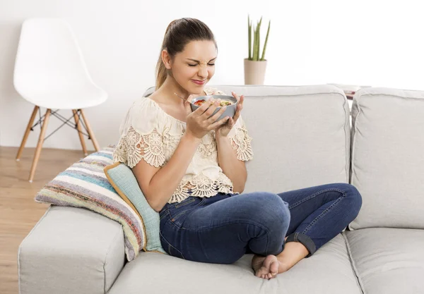 Woman at home eating a healthy food — Stock Photo, Image