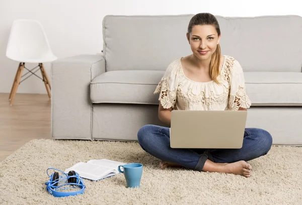 Жінка вдома працює на ноутбуці — стокове фото