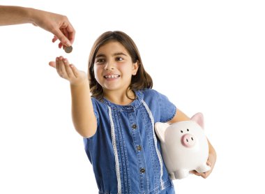 Girl start her savings on a piggybank clipart