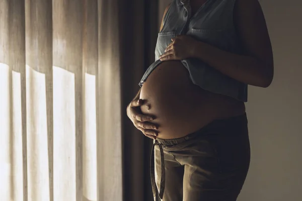 怀孕的女人早上摸她的肚子 — 图库照片