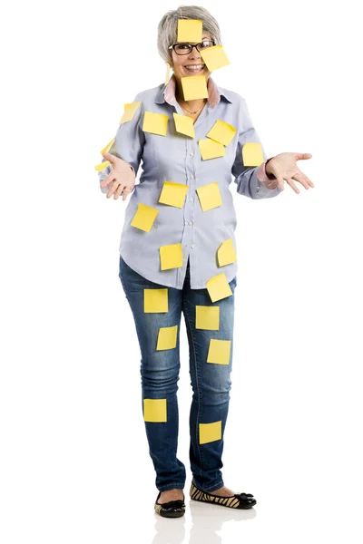 Elderly woman with yellow notes — Stock Photo, Image