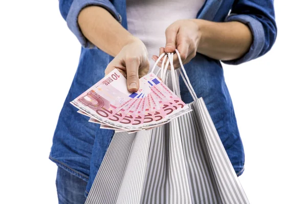 Mujer sosteniendo bolsas de compras y euro —  Fotos de Stock