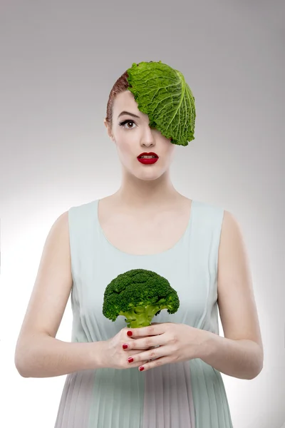 Woman with a cabbage on the head — Stock Photo, Image