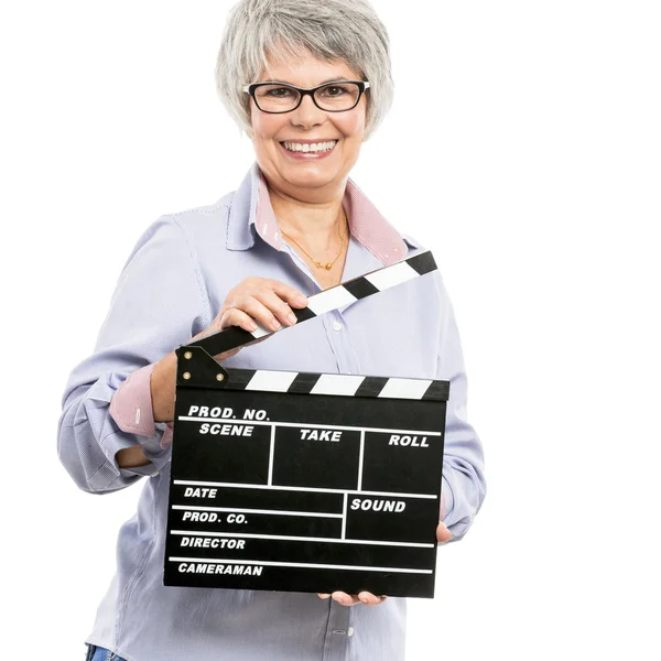 Elderly woman holding a clapboard — Stock Photo, Image