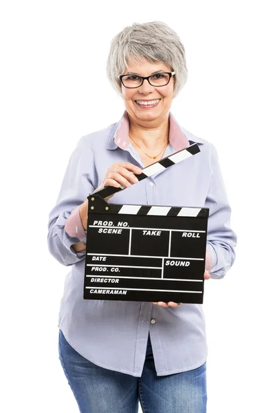 Elderly woman holding a clapboard — Stock Photo, Image