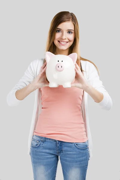 Mulher loira com um banco porquinho — Fotografia de Stock