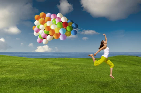 Flicka med färgglada ballonger Stockbild