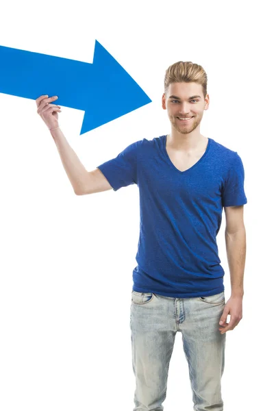 Young man holding a blue arrow — Stock Photo, Image