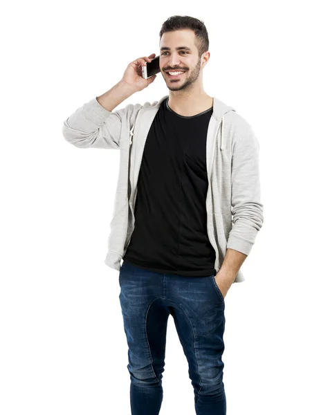 Ung man talar i mobiltelefon — Stockfoto