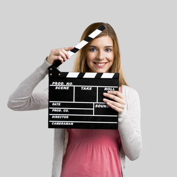 Beautiful girl holding clapboard — Stock Photo, Image