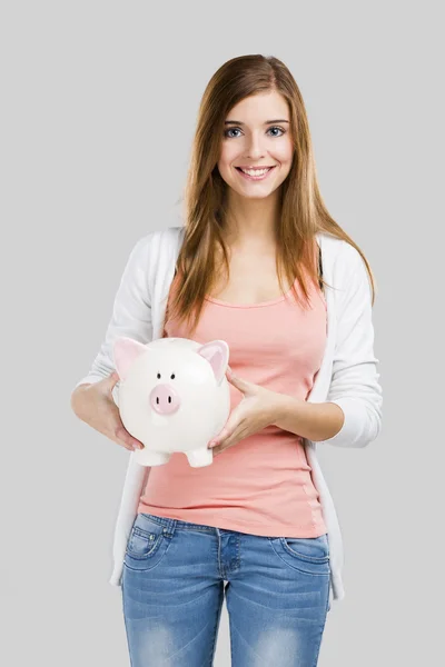 Blonde vrouw met een piggy bank — Stockfoto