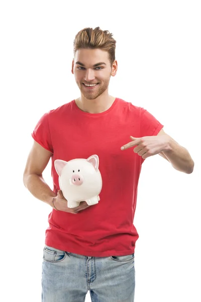 Bonito jovem segurando um banco porquinho — Fotografia de Stock