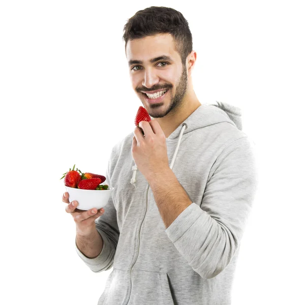 Happy man eating a strawberry — Stock Photo, Image