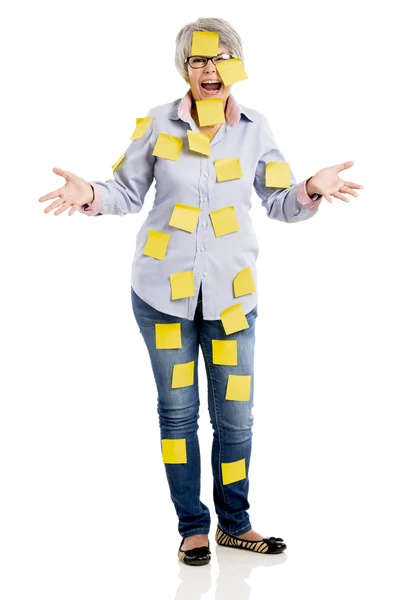 Elderly woman with yellow notes — Stock Photo, Image