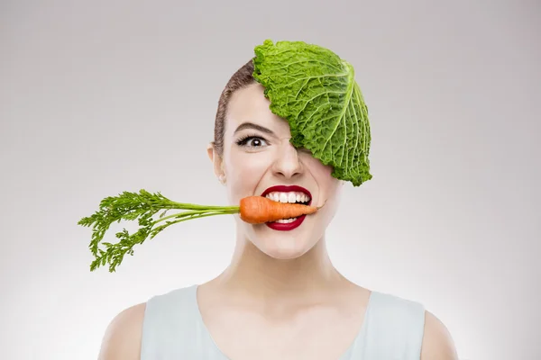 Woman with a carrot in mouth. — Stock Photo, Image