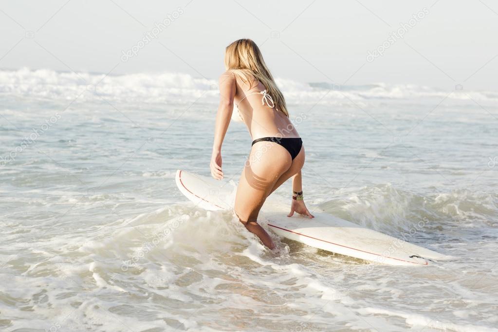 Young girl surfing in sea