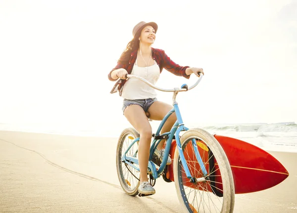 Surfer Mujer montar en bicicleta en la playa — Foto de Stock