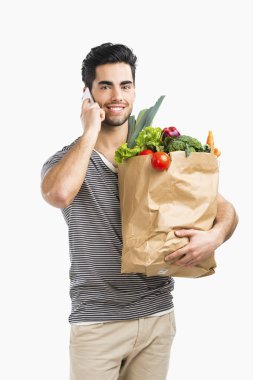 Sebze dolu bir çanta taşıyan adam
