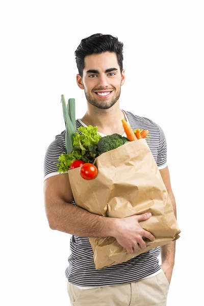 Человек с сумкой, полной овощей — стоковое фото