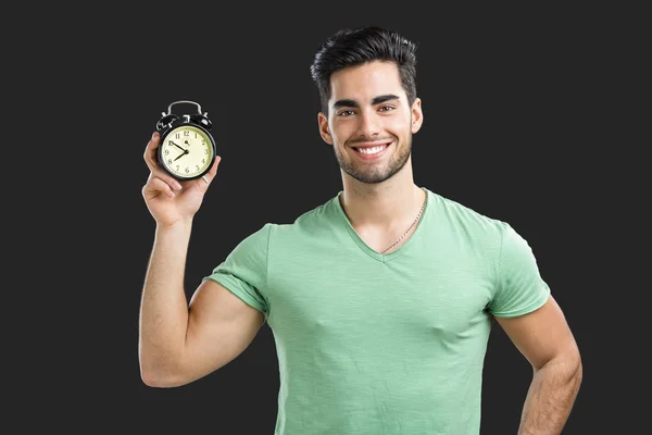Νέος άνθρωπος που κρατά ένα ρολόι — Φωτογραφία Αρχείου