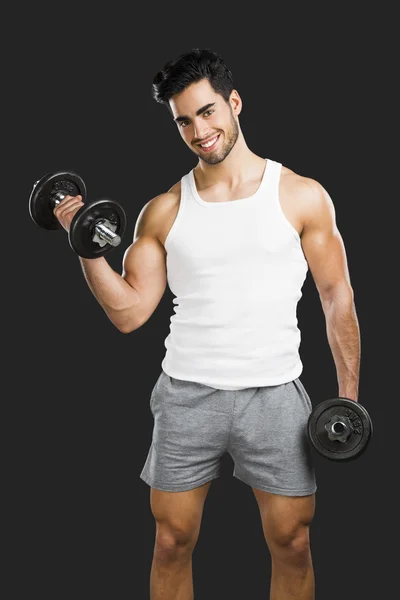 Athletic man lifting weights — Stock Photo, Image