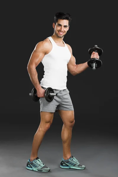 Athletic man lifting weights — Stock Photo, Image