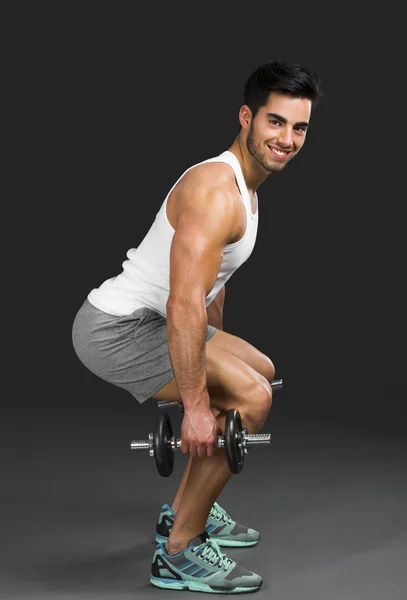 Athletic man lifting weights — Stock Photo, Image