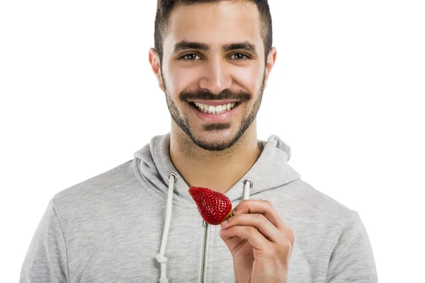 Happy young eating a strawberry — Stock Photo, Image