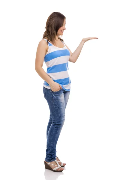 Woman smiling and showing something on her hand — Stock Photo, Image