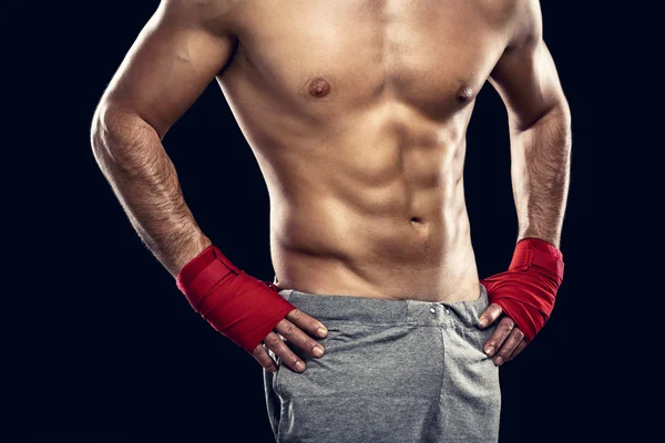 Shirtless muscular athlete in boxing bandages — Stock Photo, Image